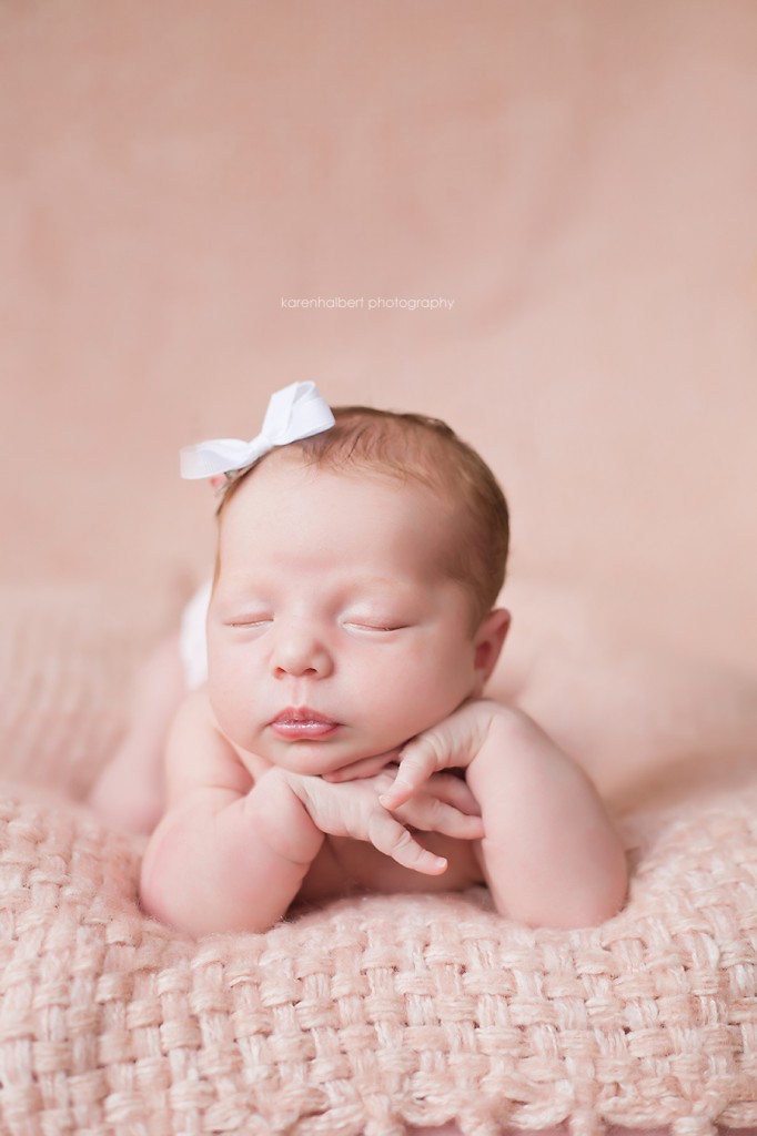 newborn girl pose head hands