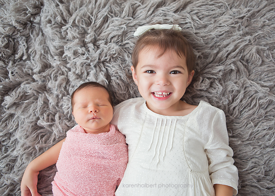 siblings newborn sisters flotaki rug gray studio -055
